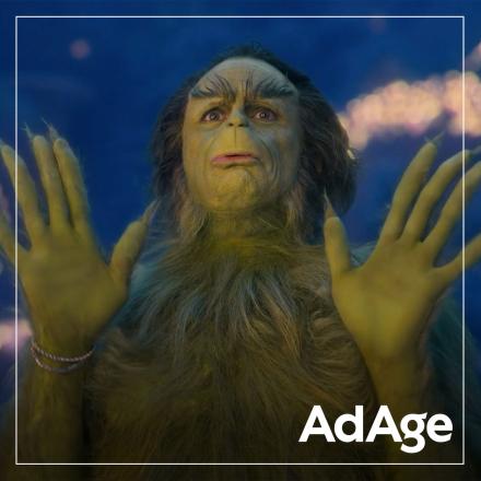 A photo of Walton Goggins as the Grinch against a snowy festive background. 