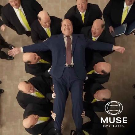 Actor Brian Baumgartner in an office setting crowd surfing with his clones