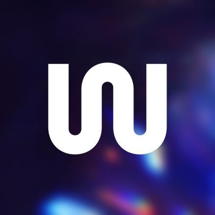 A CG background showing flares of light with a white W International Logo in the centre.