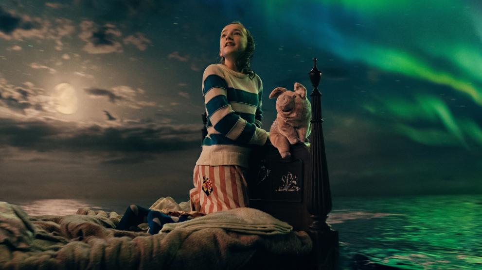 Nemo sits on her bed, with cuddly toy Pig, as it floats across an ocean