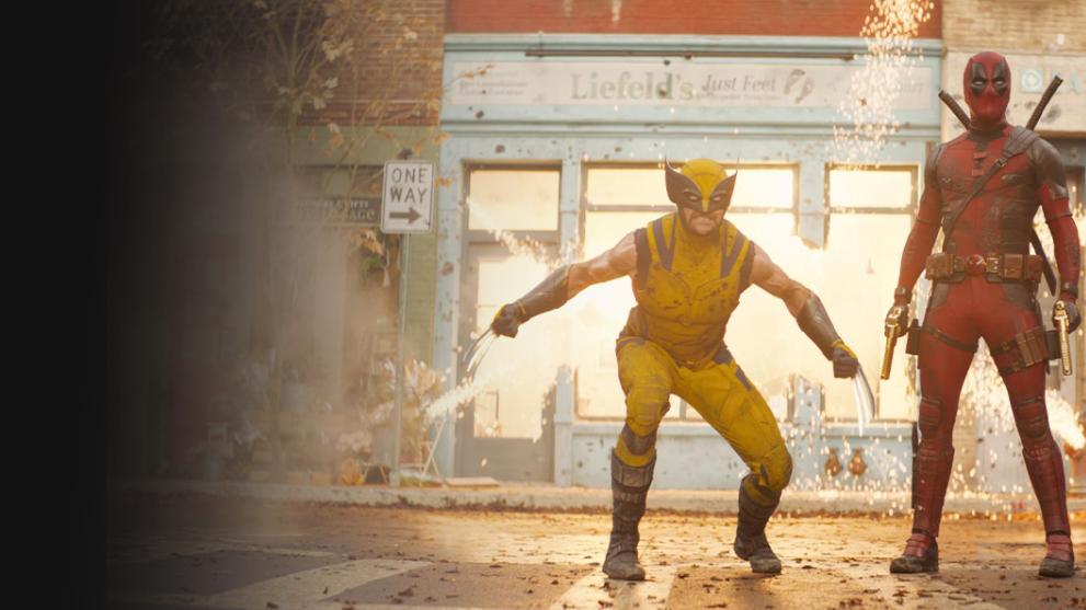 A still from Deadpool and Wolverine showing VFX explosions and the title characters in battle poses.