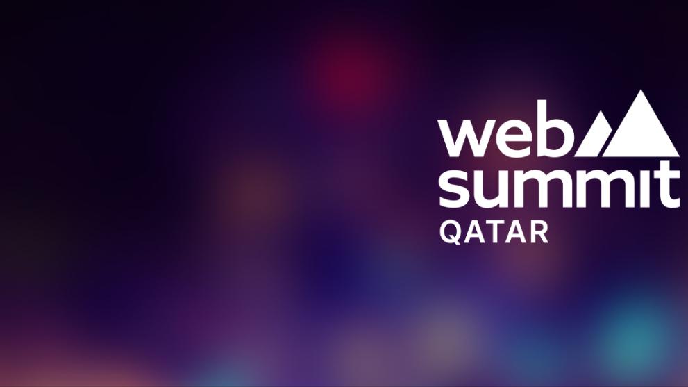 A glowing multicoloured background with a white Web Summit Qatar logo in the centre.
