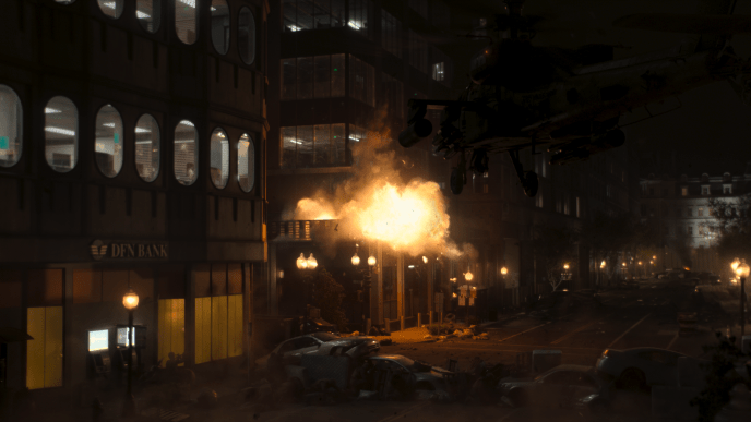 A large high rise building on fire on a dimly lit street.